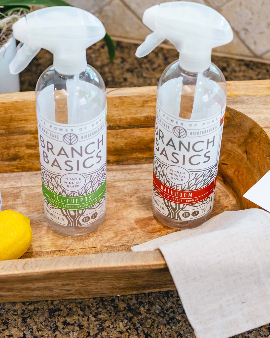 Natural cleaning products styled with lemons and linen